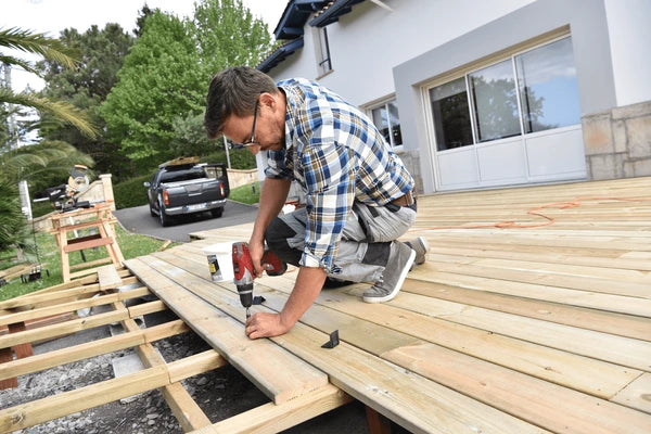 Carpenter building a wooden deck using Grindy wood screws